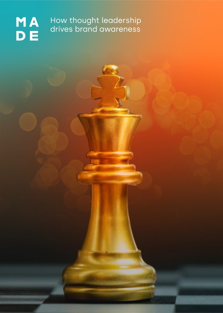 A King chess piece coloured gold and glinting, resting on a chessboard against a green and gold backdrop. The king represents thought leadership